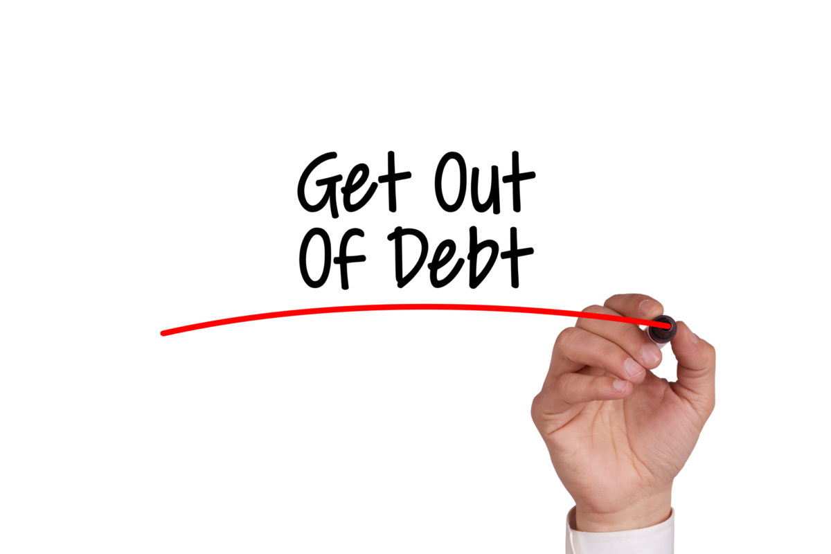 Human hand writing GET OUT OF DEBT on whiteboard