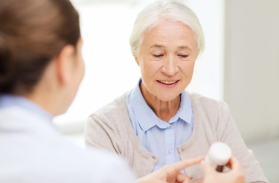 doctor with medicine and senior woman at hospital